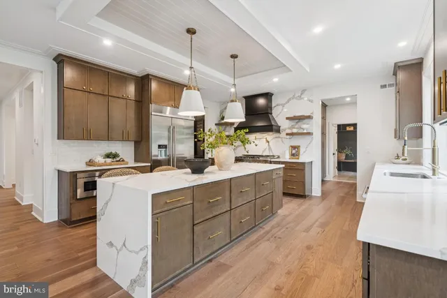 a kitchen with a sink stainless steel appliances and cabinets