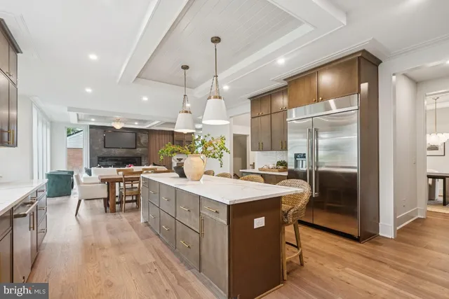 a kitchen with a sink appliances and wooden floor