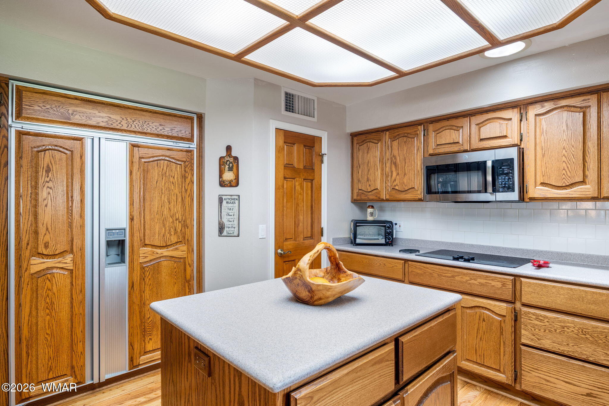 2922 Pine Rim Road Overgaard, AZ 85933 - Photo 19 of 58 a kitchen with stainless steel appliances granite countertop a refrigerator a stove and a sink with wooden floor