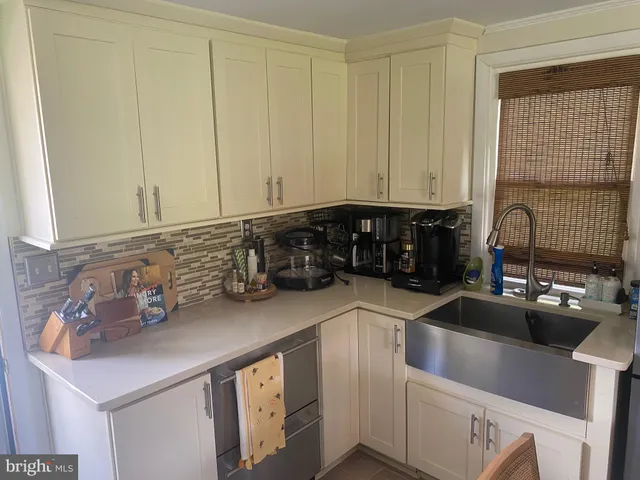 a kitchen with stainless steel appliances a sink stove and cabinets