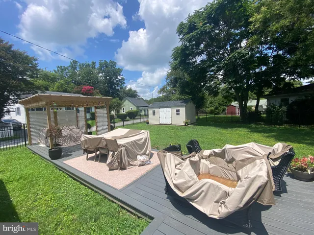 a view of a patio with couches chairs and a yard