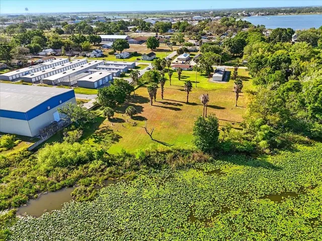 an aerial view of a house with a swimming pool yard and outdoor seating