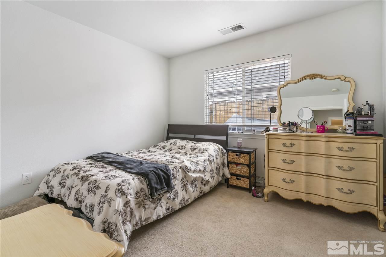9032 Gilvarry Street Reno, NV 89506 - Photo 10 of 14 a bedroom with a bed and a dresser