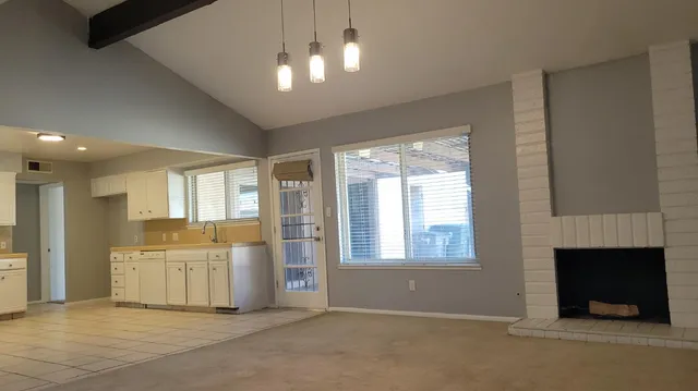 a view of a kitchen with furniture and a fireplace