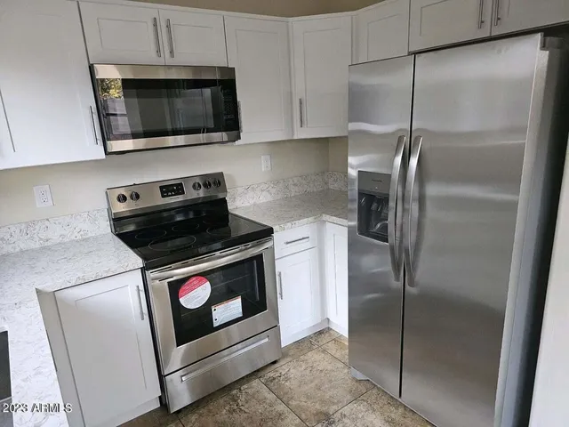 a kitchen with a stove microwave and refrigerator
