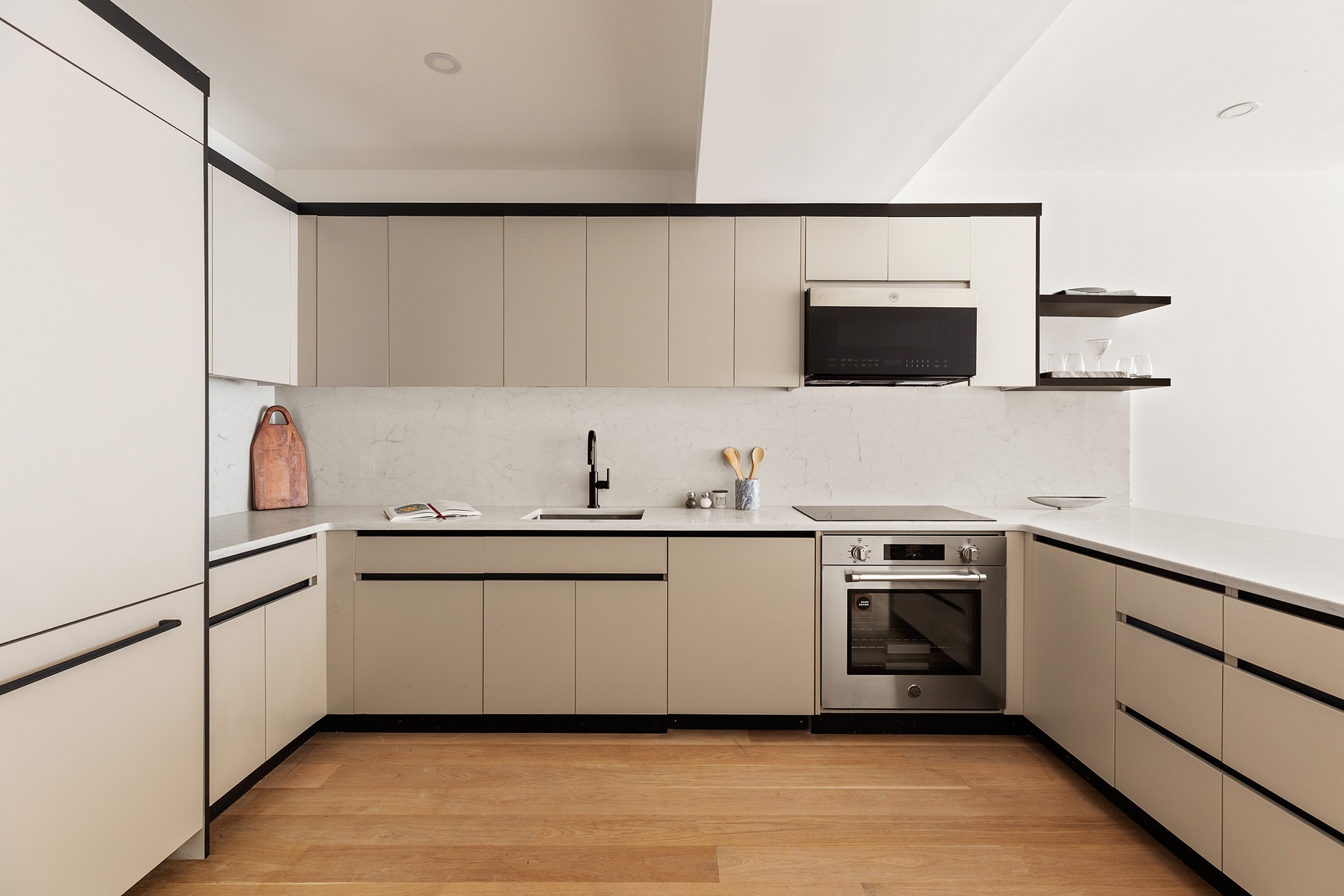 a kitchen with stainless steel appliances a sink and a microwave