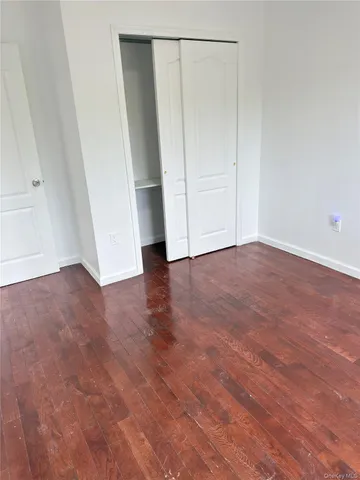 an empty room with wooden floor