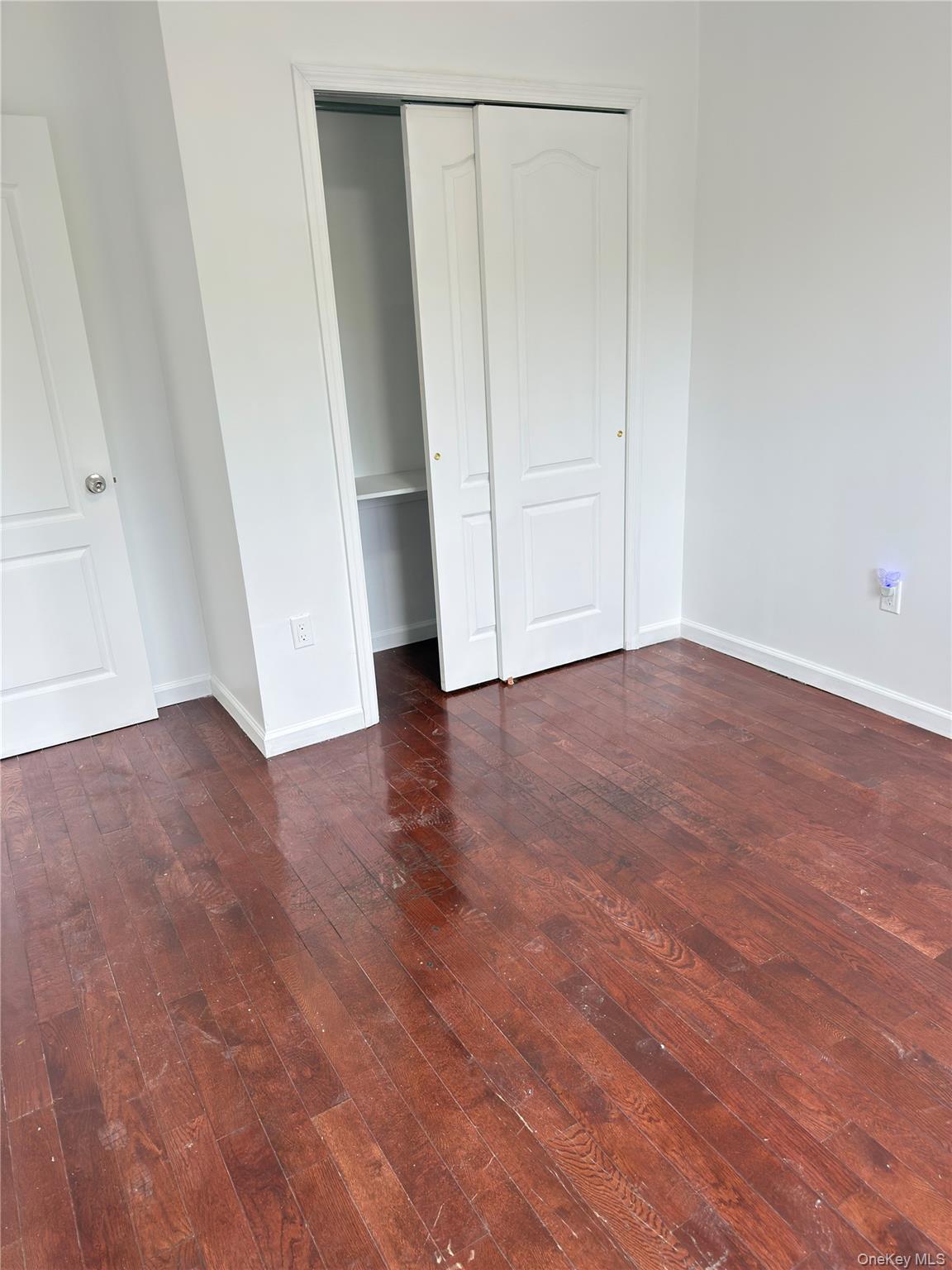 49-10 111th Street, Unit 3A Queens, NY 11368 - Photo 3 of 8 an empty room with wooden floor