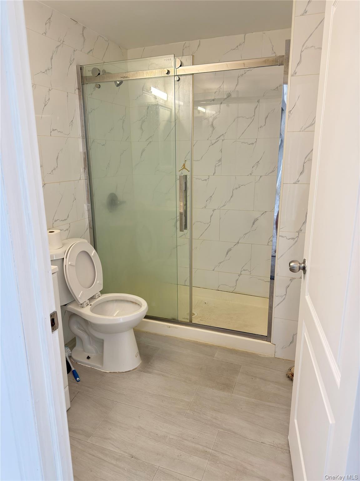 49-10 111th Street, Unit 3A Queens, NY 11368 - Photo 6 of 8 a bathroom with a toilet and a shower