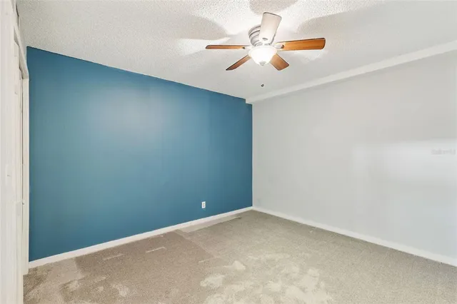 an empty room with a fan