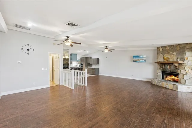 a view of a livingroom with a fireplace and window