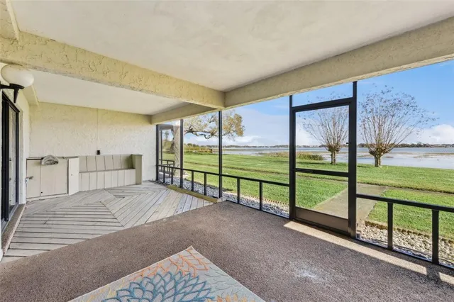 a view of a big room with floor to ceiling window and an outdoor view