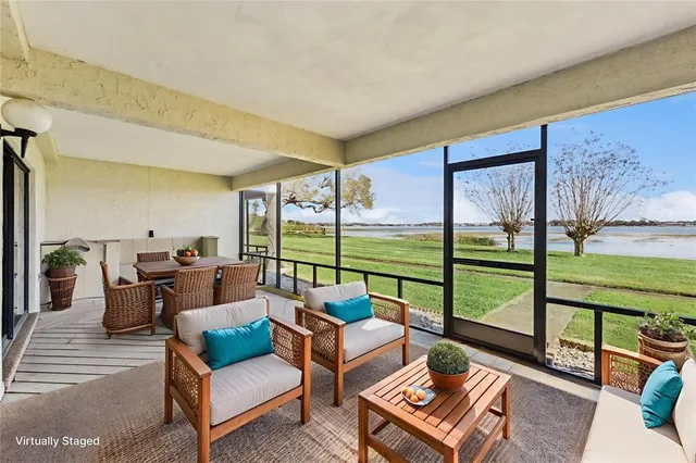 a living room with furniture and a floor to ceiling window