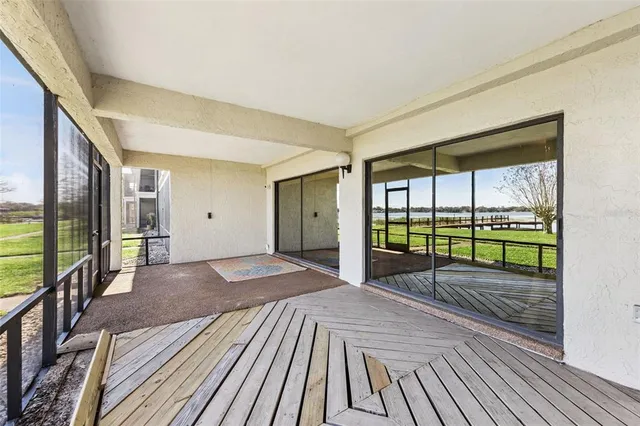 a view of a bedroom with wooden floor and balcony