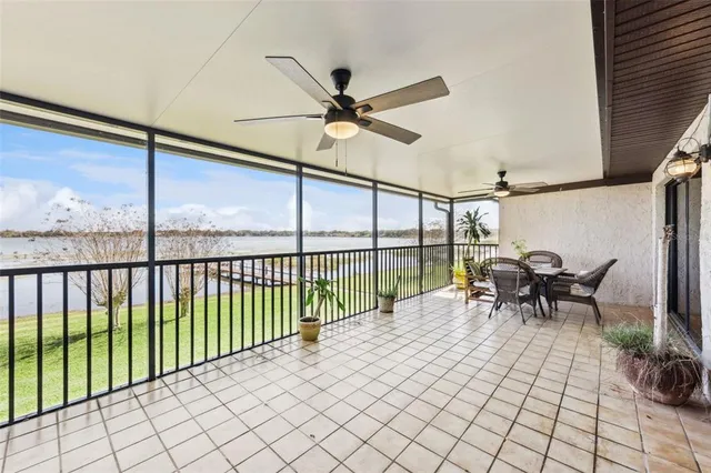 a view of a chairs and table in patio with a backyard
