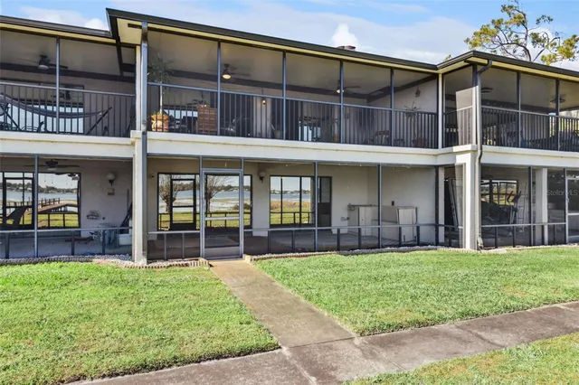 front view of a brick building with a yard