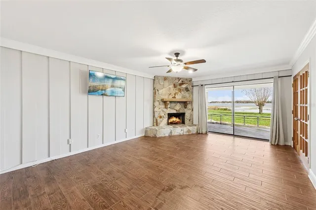 a view of a livingroom with a ceiling fan and a hardwood floor