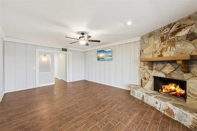 a view of an empty room with a fireplace