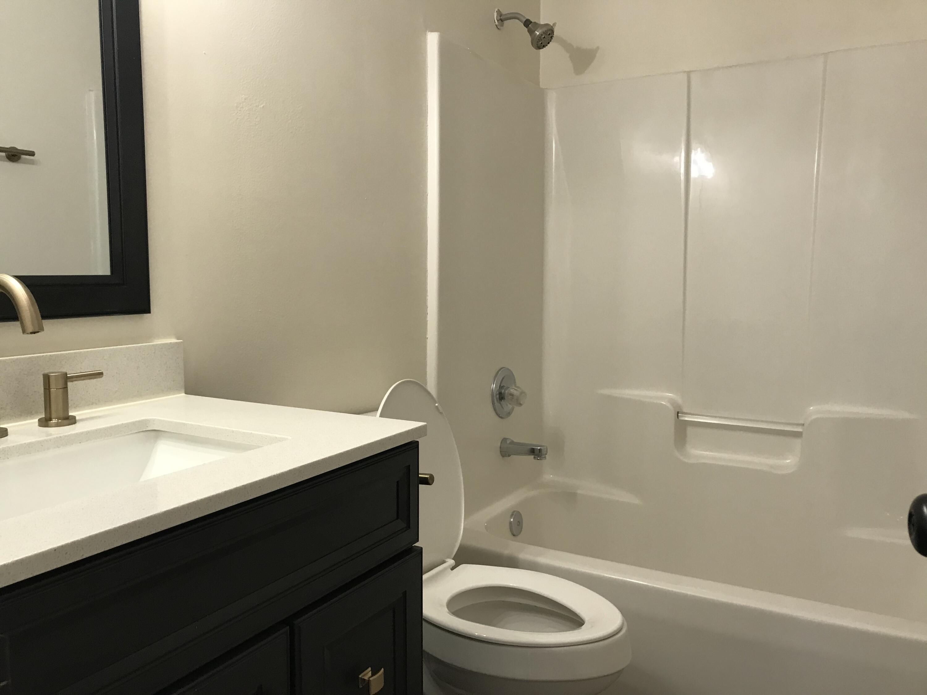 113 Oak Terrace Drive Crestview, FL 32539 - Photo 12 of 21 a bathroom with a sink a toilet a mirror and shower