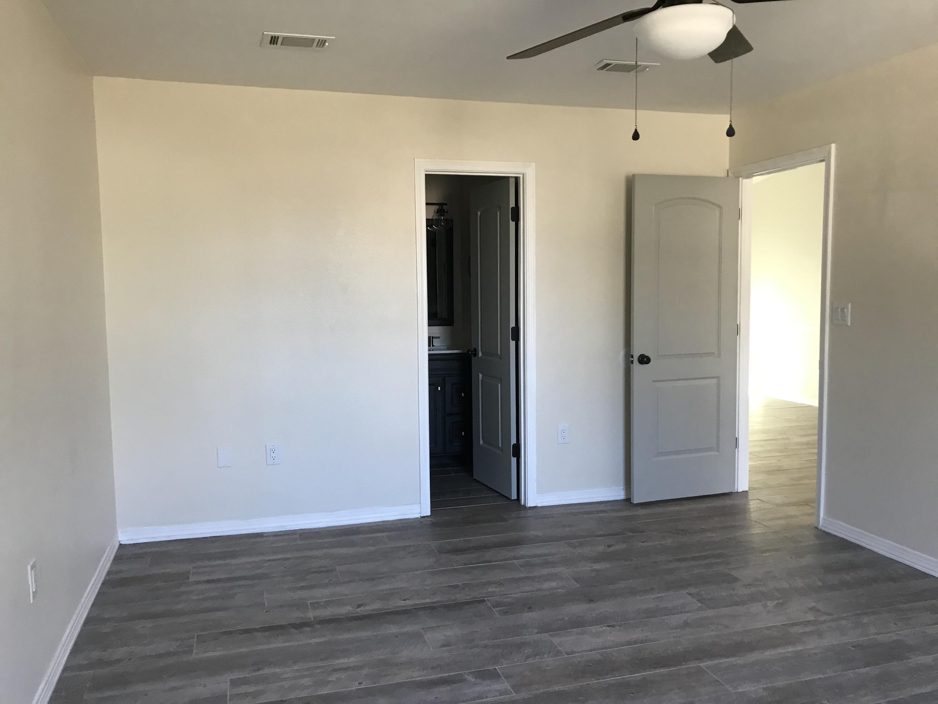 113 Oak Terrace Drive Crestview, FL 32539 - Photo 18 of 21 a view of an empty room with wooden floor