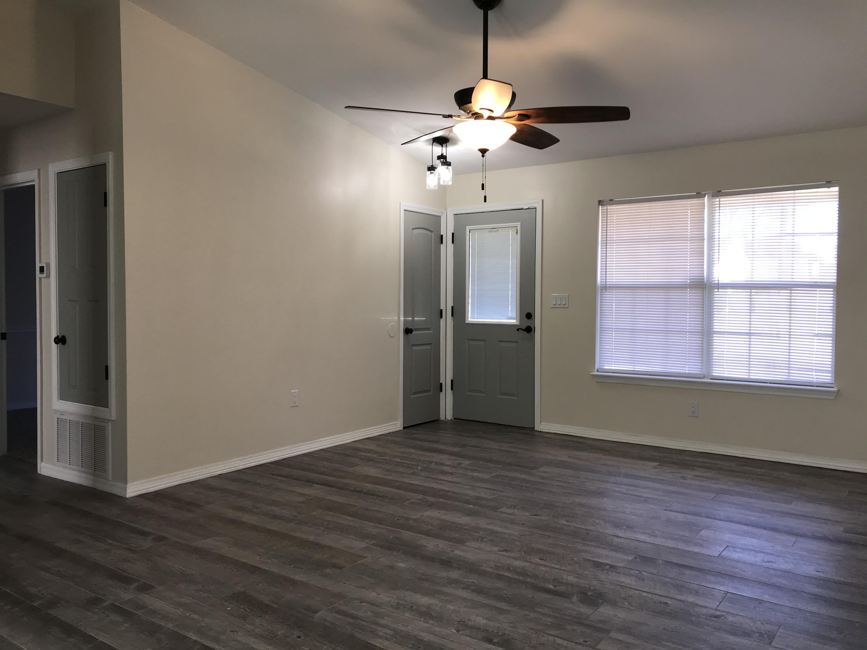 113 Oak Terrace Drive Crestview, FL 32539 - Photo 3 of 21 a view of an empty room with wooden floor and a window