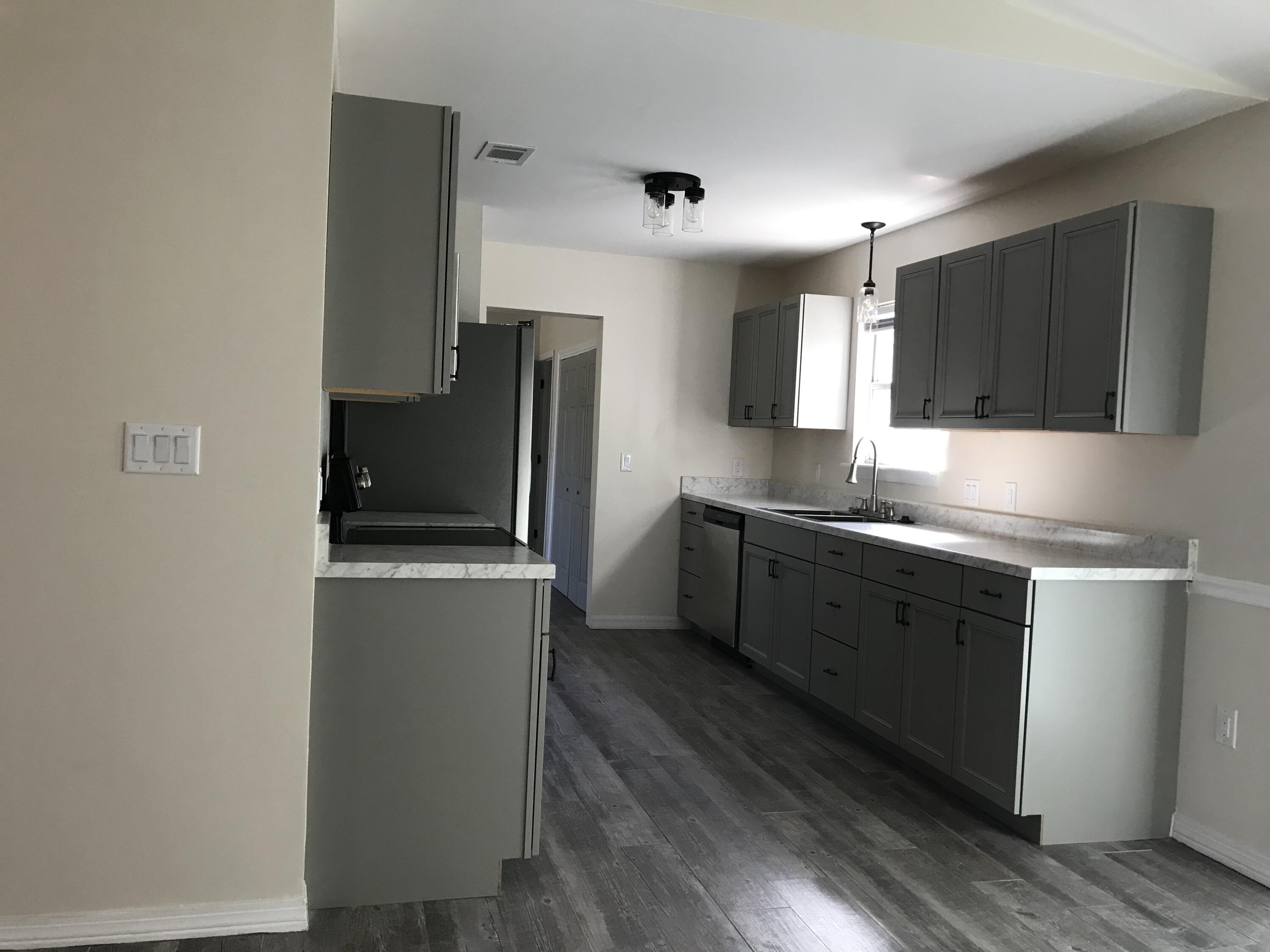 113 Oak Terrace Drive Crestview, FL 32539 - Photo 6 of 21 a kitchen with stainless steel appliances a refrigerator stove and sink