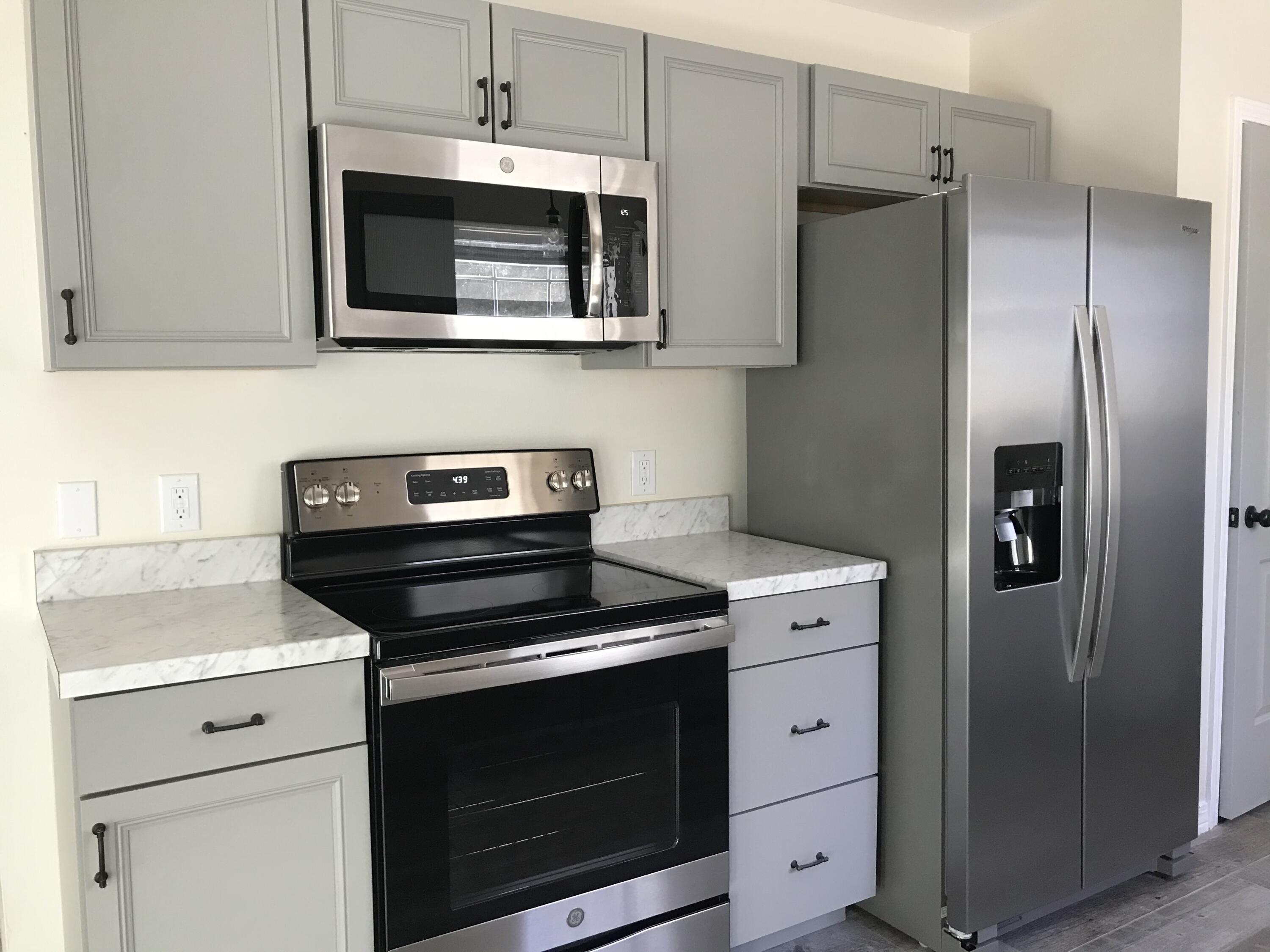 113 Oak Terrace Drive Crestview, FL 32539 - Photo 8 of 21 a kitchen with stainless steel appliances white cabinets and a stove top oven