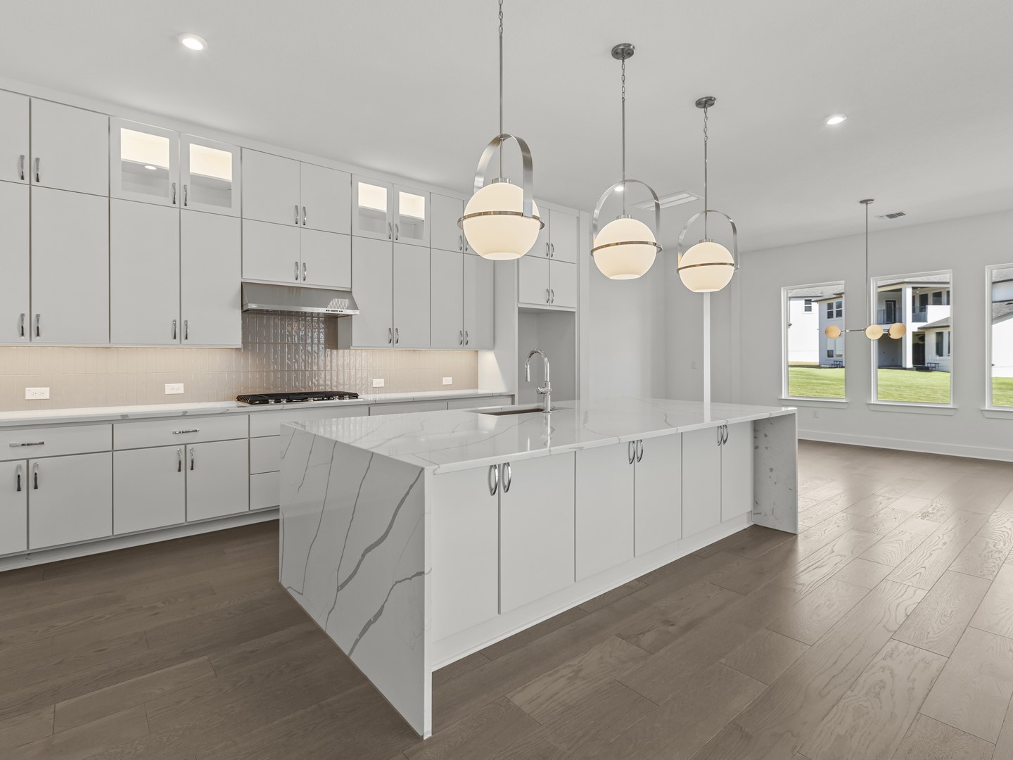 2508 Chiavari Way Leander, TX 78641 - Photo 9 of 24 Culinary dreams come alive in this kitchen with sleek quartz countertops and a modern island.