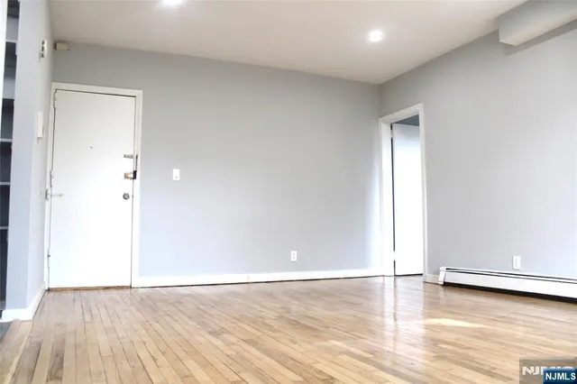 a view of an empty room and wooden floor