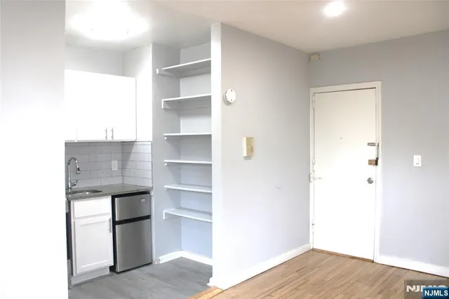 a view of storage and utility room with cabinet and stairs