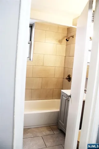 a bathroom with a bathtub and shower