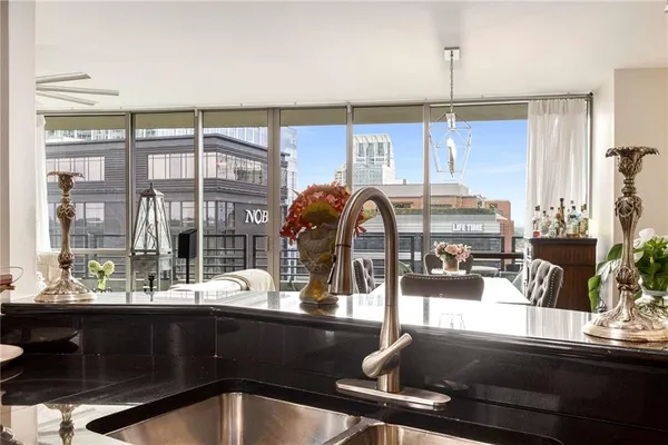 a kitchen with a sink and living room view