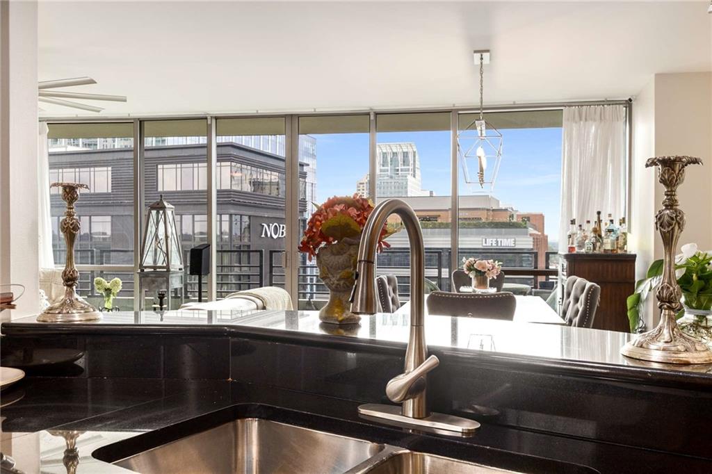 700 Park Regency Place Northeast, Unit 1603 Atlanta, GA 30326 - Photo 15 of 25 a kitchen with a sink and living room view