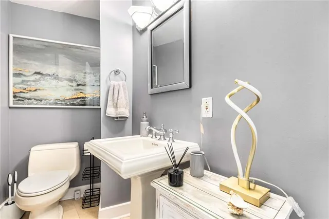 a bathroom with a toilet a sink and mirror