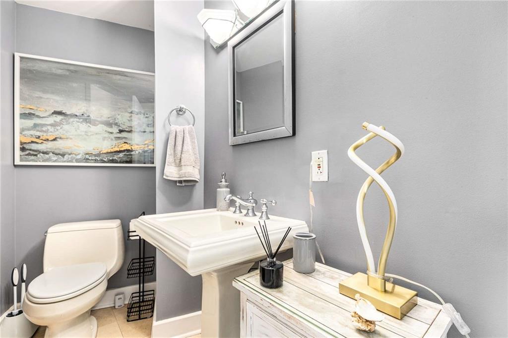 700 Park Regency Place Northeast, Unit 1603 Atlanta, GA 30326 - Photo 19 of 25 a bathroom with a toilet a sink and mirror
