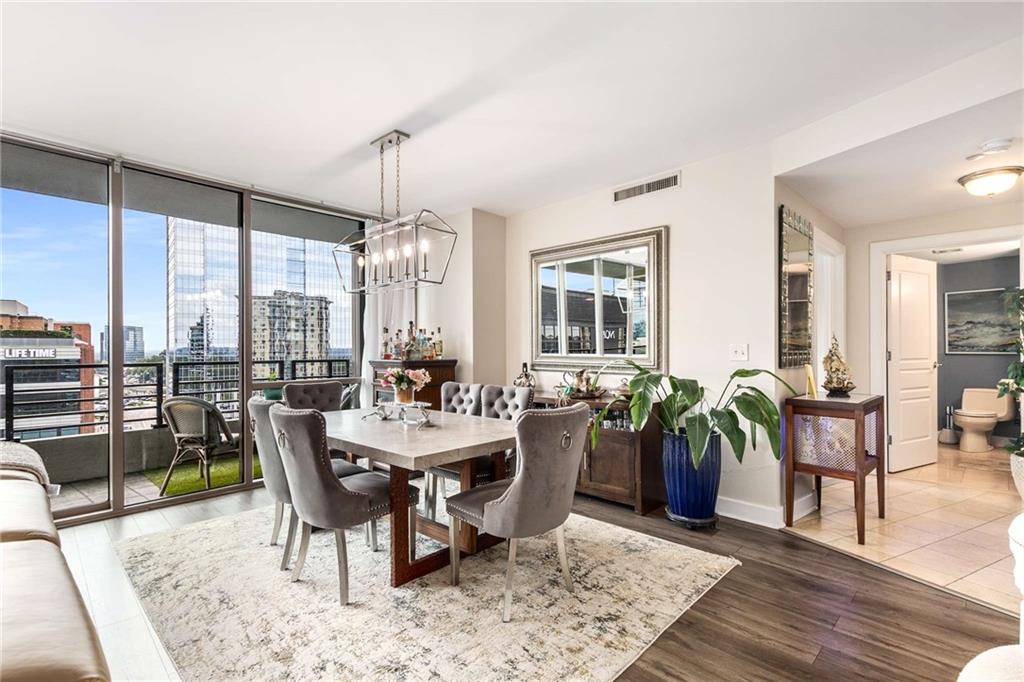 700 Park Regency Place Northeast, Unit 1603 Atlanta, GA 30326 - Photo 2 of 25 a view of a dining room with furniture window and wooden floor