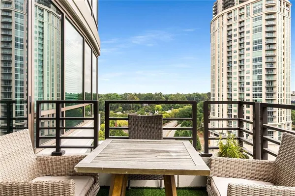 a roof deck with a table and chairs and wooden floor