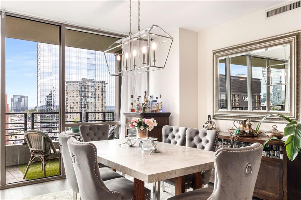 700 Park Regency Place Northeast, Unit 1603 Atlanta, GA 30326 - Photo 3 of 25 a view of a dining room with furniture window and outside view