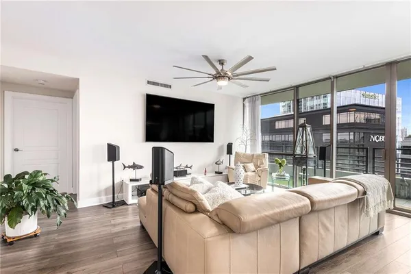 a living room with furniture fireplace and a flat screen tv