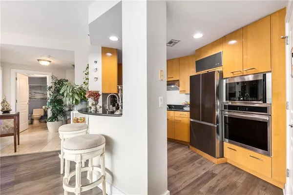 a kitchen with stainless steel appliances a refrigerator and a stove