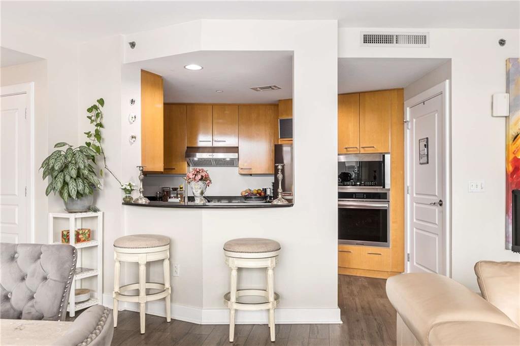 700 Park Regency Place Northeast, Unit 1603 Atlanta, GA 30326 - Photo 10 of 25 a kitchen with a table and chairs