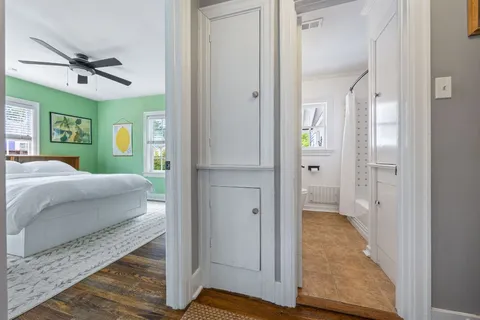 a bedroom with a bed and a glass door