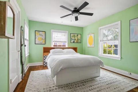 a spacious bedroom with a bed and a window