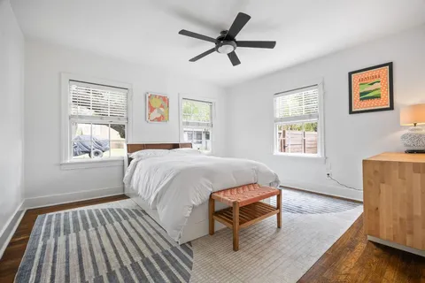 a spacious bedroom with a bed and a window