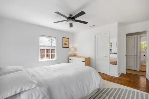 a bedroom with a large bed and a chandelier