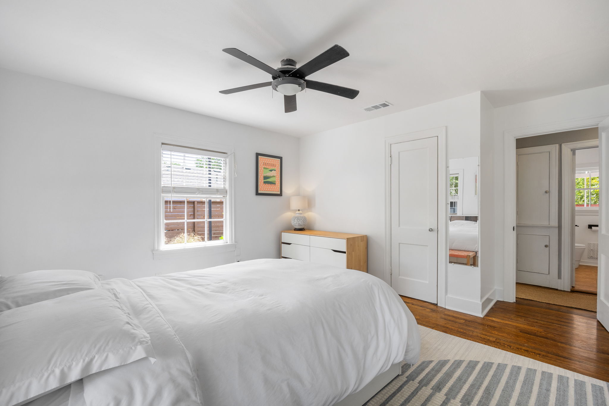 305 East 50th Street Austin, TX 78751 - Photo 24 of 40 a bedroom with a large bed and a chandelier