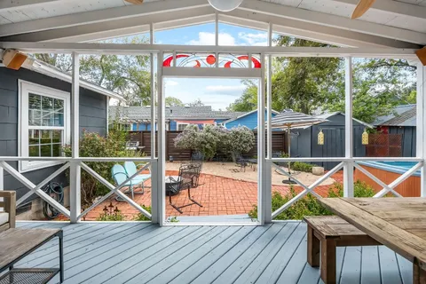 a view of a chairs with a table in the balcony