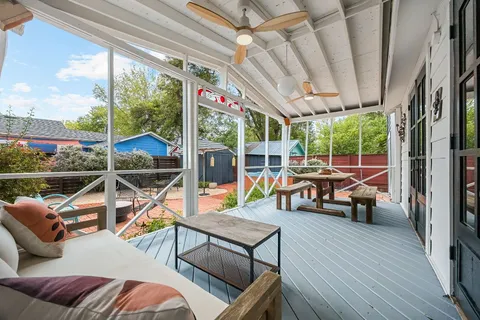 a view of living room with patio furniture and wooden floor