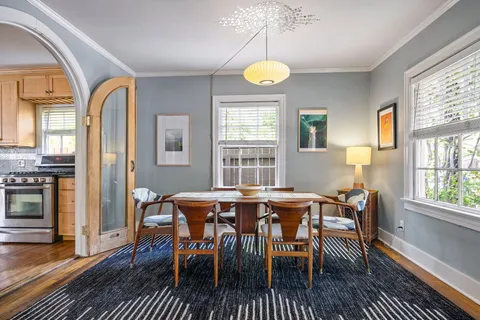 a view of a dining room with furniture window and wooden floor