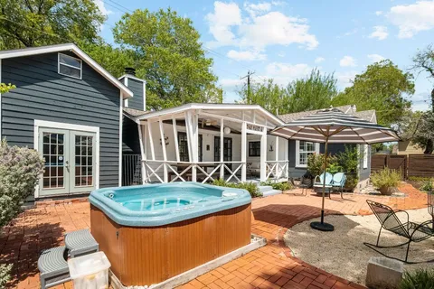 a view of a house with backyard and sitting area